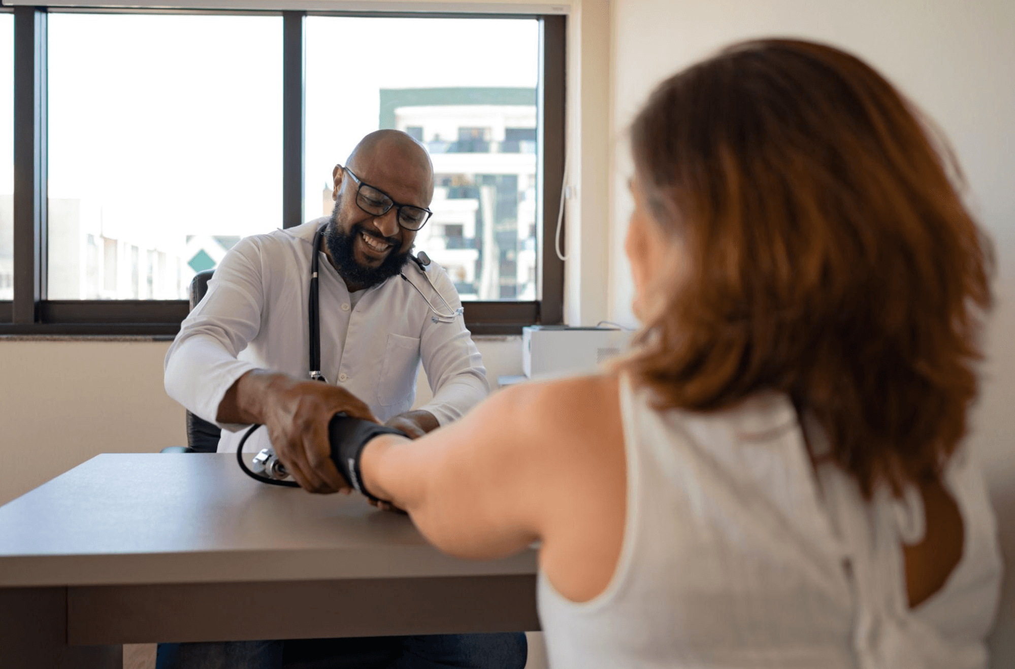 Doctor taking patient's blood pressure