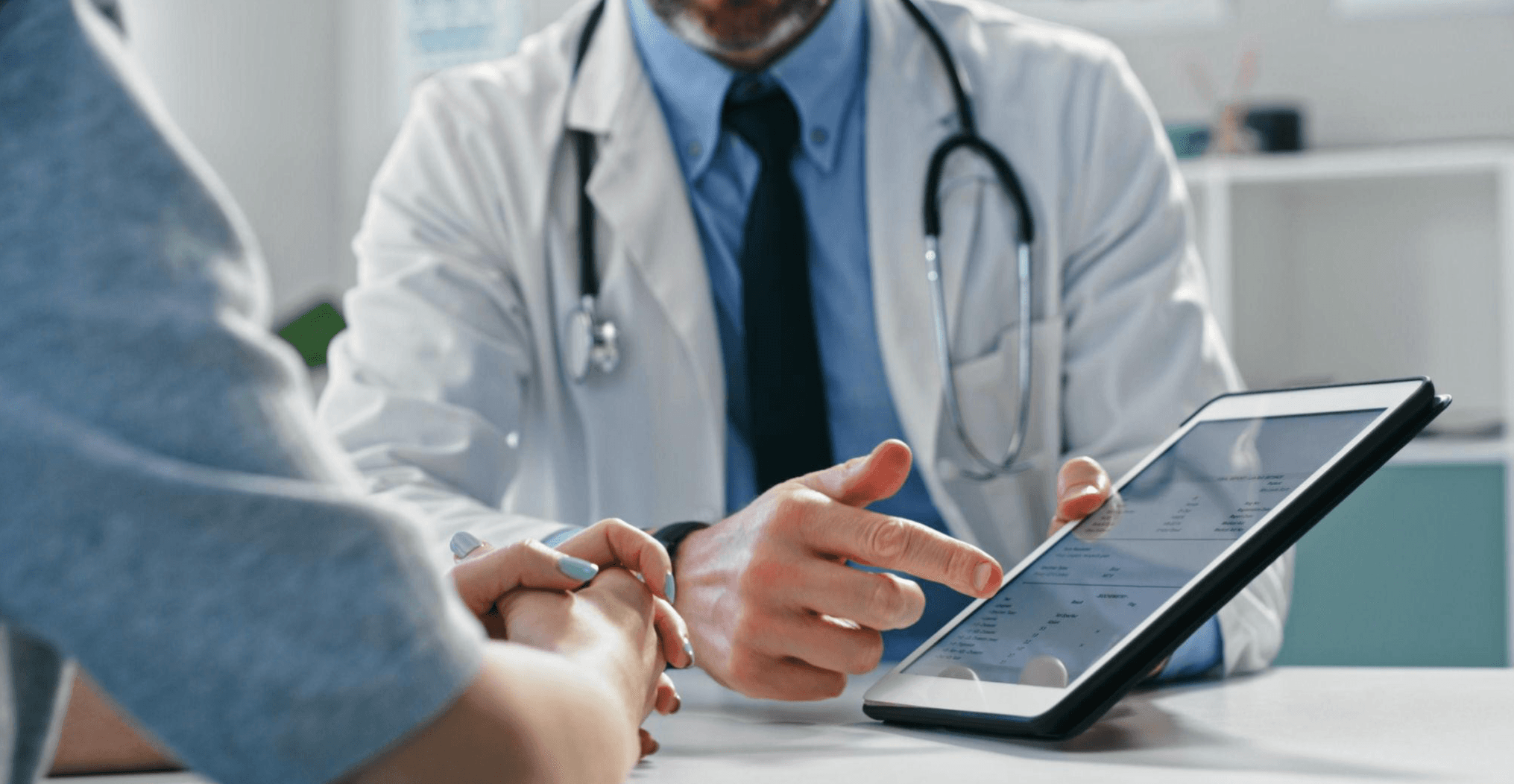 Doctor reviewing results with patient on tablet
